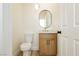 Quaint powder room featuring a sleek vanity, modern mirror, and tiled floor, exuding minimalist charm at 4493 Rometta Ave, Las Vegas, NV 89141