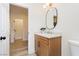 Well-lit bathroom features a modern vanity with quartz countertop, a sleek mirror and contemporary fixtures at 4493 Rometta Ave, Las Vegas, NV 89141