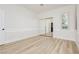 Clean bedroom features a mirrored closet, window with shutters, wood-look tile flooring, and crisp white trim at 4493 Rometta Ave, Las Vegas, NV 89141