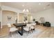 Open-concept dining room featuring a stylish chandelier, light wood flooring and comfortable seating at 4493 Rometta Ave, Las Vegas, NV 89141