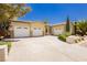 Expansive driveway leads to a three-car garage, showcasing curb appeal and ample parking space at 4493 Rometta Ave, Las Vegas, NV 89141