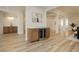 Open-concept hallway with a wine cooler and light wood-style floors leading to other rooms at 4493 Rometta Ave, Las Vegas, NV 89141