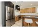 Contemporary kitchen boasts stainless steel refrigerator, light wood cabinets, and a sleek black range hood at 4493 Rometta Ave, Las Vegas, NV 89141