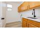 Functional laundry room features ample cabinet space, a deep sink, and stylish fixtures at 4493 Rometta Ave, Las Vegas, NV 89141