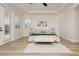 Well-lit bedroom features white walls, French doors to backyard, and a stylish accent wall decor at 4493 Rometta Ave, Las Vegas, NV 89141