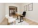 Well-lit office area with a modern desk, comfortable chairs, and an open view into other rooms at 4493 Rometta Ave, Las Vegas, NV 89141