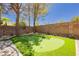 View of backyard putting green with desert landscaping and block wall at 4493 Rometta Ave, Las Vegas, NV 89141