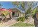 A well-manicured backyard with stone groundcover and decorative plants and stone wall at 4672 Regalo Bello St, Las Vegas, NV 89135
