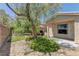 Serene backyard featuring a charming patio, privacy wall, and lush desert landscaping at 4672 Regalo Bello St, Las Vegas, NV 89135