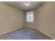 Carpeted bedroom features a ceiling fan and a window letting in ample natural light at 4672 Regalo Bello St, Las Vegas, NV 89135