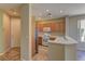 Bright kitchen with stainless steel refrigerator, white appliances, and light wood cabinets at 4672 Regalo Bello St, Las Vegas, NV 89135