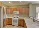 Well-lit kitchen boasts stainless steel refrigerator, white oven and light-colored wood cabinetry at 4672 Regalo Bello St, Las Vegas, NV 89135