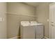 View of a laundry room, including a washer, dryer, and wire shelving at 4672 Regalo Bello St, Las Vegas, NV 89135