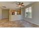 Open living area with tile flooring, a ceiling fan and connection to the kitchen area at 4672 Regalo Bello St, Las Vegas, NV 89135