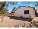 The backyard has a covered patio and mature trees at 4775 Woodridge Rd, Las Vegas, NV 89121