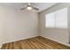 This bedroom features a ceiling fan and wood-look flooring at 4775 Woodridge Rd, Las Vegas, NV 89121