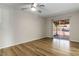 Bedroom features sliding glass door with access to a patio, ceiling fan and wood floors at 4775 Woodridge Rd, Las Vegas, NV 89121