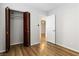 This bedroom features a closet with bi-fold doors and wood-look floors at 4775 Woodridge Rd, Las Vegas, NV 89121