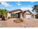 Inviting single-story house showcasing a desert landscape, flower bed and charming curb appeal at 4775 Woodridge Rd, Las Vegas, NV 89121