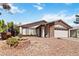 This house features a well-kept desert landscape, flower bed and charming curb appeal at 4775 Woodridge Rd, Las Vegas, NV 89121