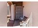 Welcoming front entry with ornate bench seating outside a security door at 4775 Woodridge Rd, Las Vegas, NV 89121