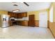 Bright eat-in kitchen features stainless steel appliances, tile floors, and wooden cabinetry at 4775 Woodridge Rd, Las Vegas, NV 89121