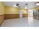Open kitchen showcases stainless steel refrigerator, tile flooring, and ceiling fan at 4775 Woodridge Rd, Las Vegas, NV 89121