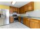 This kitchen offers stainless appliances, tile backsplash, and wooden cabinets at 4775 Woodridge Rd, Las Vegas, NV 89121