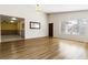 This spacious living room features wood floors, ceiling fan and neutral paint at 4775 Woodridge Rd, Las Vegas, NV 89121