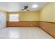 This living room features tile flooring, chair railing, and a ceiling fan at 4775 Woodridge Rd, Las Vegas, NV 89121