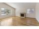 Inviting living area boasts hardwood floors, a fireplace, and plenty of sunlight through windows at 4775 Woodridge Rd, Las Vegas, NV 89121