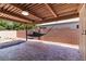 Covered patio with unique pavers and hammock creates an inviting outdoor retreat at 4775 Woodridge Rd, Las Vegas, NV 89121