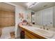 Well-lit bathroom featuring tile floors, a sink with vanity, and decorative tile shower at 5133 Southern Hills Ln, Las Vegas, NV 89113