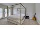 Primary bedroom with a four-poster bed frame, plush carpeting and access to an outdoor balcony at 5133 Southern Hills Ln, Las Vegas, NV 89113