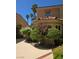 Landscaped front yard featuring red brick-lined walkway, mature bushes, and well-manicured trees at 5133 Southern Hills Ln, Las Vegas, NV 89113