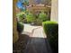 Front yard with tidy landscaping featuring shrubs, bushes, and a brick-lined walkway leading up to the home at 5133 Southern Hills Ln, Las Vegas, NV 89113