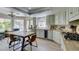 Bright kitchen with modern appliances, dining table, wine cooler, and stylish countertops at 5133 Southern Hills Ln, Las Vegas, NV 89113