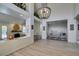 Spacious living room featuring a chandelier, elevated seating area and fireplace with white brick hearth at 5133 Southern Hills Ln, Las Vegas, NV 89113