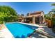 Beautiful backyard pool with a diving board and seating area, perfect for outdoor entertainment and relaxation at 5133 Southern Hills Ln, Las Vegas, NV 89113