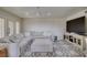 Comfortable sitting room featuring a sectional sofa, large television and plush carpeting at 5133 Southern Hills Ln, Las Vegas, NV 89113