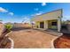 Backyard with covered patio featuring rock garden and ready for landscaping at 5907 Soft Mist Ct, Las Vegas, NV 89110