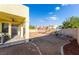 The backyard features a covered patio, rock garden and fresh landscaping opportunity at 5907 Soft Mist Ct, Las Vegas, NV 89110