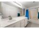 Bathroom featuring large mirror and vanity, toilet and shower-tub combo at 5907 Soft Mist Ct, Las Vegas, NV 89110