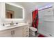 Bathroom featuring a lighted mirror, single sink vanity, toilet, and shower stall at 5907 Soft Mist Ct, Las Vegas, NV 89110