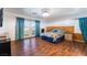 Spacious bedroom with hardwood floors, natural light, and access to outdoor patio at 5907 Soft Mist Ct, Las Vegas, NV 89110
