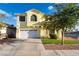 Charming two-story home featuring a two-car garage, manicured lawn, and beautiful landscaping at 5907 Soft Mist Ct, Las Vegas, NV 89110