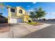 Charming two-story home featuring a two-car garage, manicured lawn, and beautiful landscaping at 5907 Soft Mist Ct, Las Vegas, NV 89110
