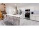 Modern kitchen with stainless steel appliances, white cabinetry, and a center island with seating at 5907 Soft Mist Ct, Las Vegas, NV 89110