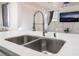 Close-up of the kitchen island featuring a modern faucet and stainless steel double sink at 5907 Soft Mist Ct, Las Vegas, NV 89110
