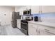 Updated kitchen featuring stainless steel appliances, quartz countertops, and ample cabinet space at 5907 Soft Mist Ct, Las Vegas, NV 89110